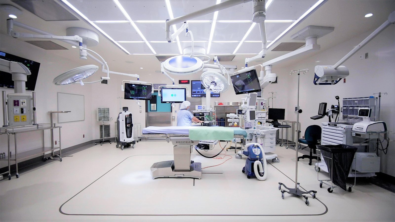 Biomedical engineer inspecting hospital equipment during a preventive maintenance visit